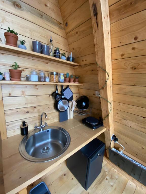 a kitchen with a sink in a wooden cabin at Horizon Lodge Medurec in Ulcinj
