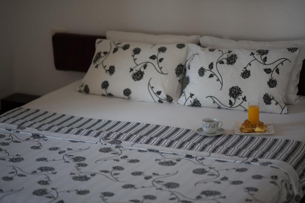 a bed with black and white sheets and pillows at Spa Resort Luxury Apartments in Budva