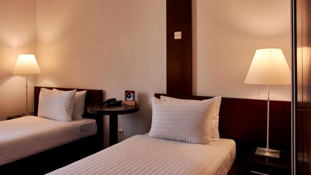 Postel nebo postele na pokoji v ubytování Hotel Concordia