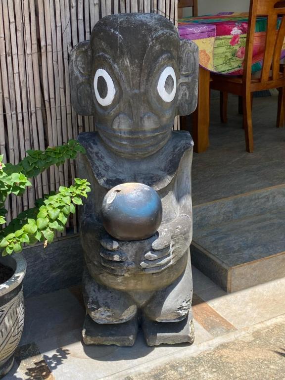 a statue of a bear holding a ball at Tiki House in Bora Bora