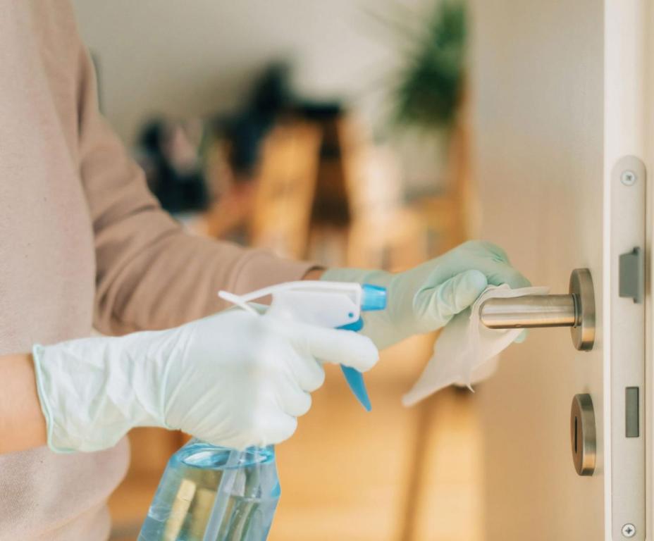 a person opening a door with a pair of gloves at Spa Resort Luxury Apartments in Budva