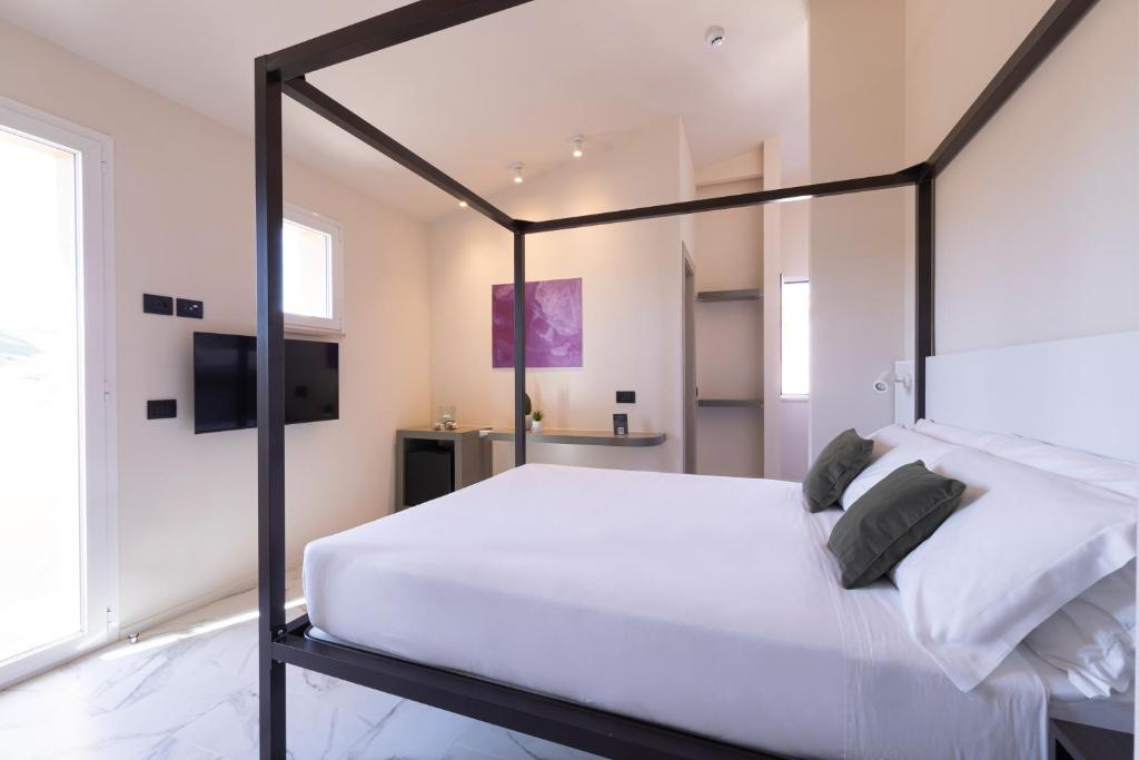 Postel nebo postele na pokoji v ubytování Pietra Bianca Hotel