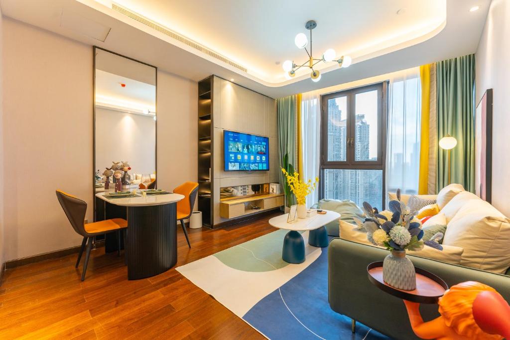 a living room with a couch and a table at Locals Apartment Place 25 in Hankou