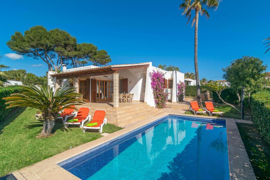 a villa with a swimming pool and a house at Villa Pastor in Cala Anguila