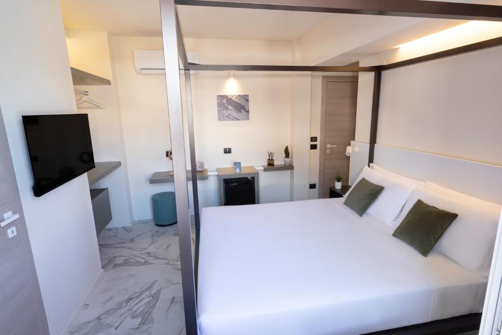 Postel nebo postele na pokoji v ubytování Pietra Bianca Hotel