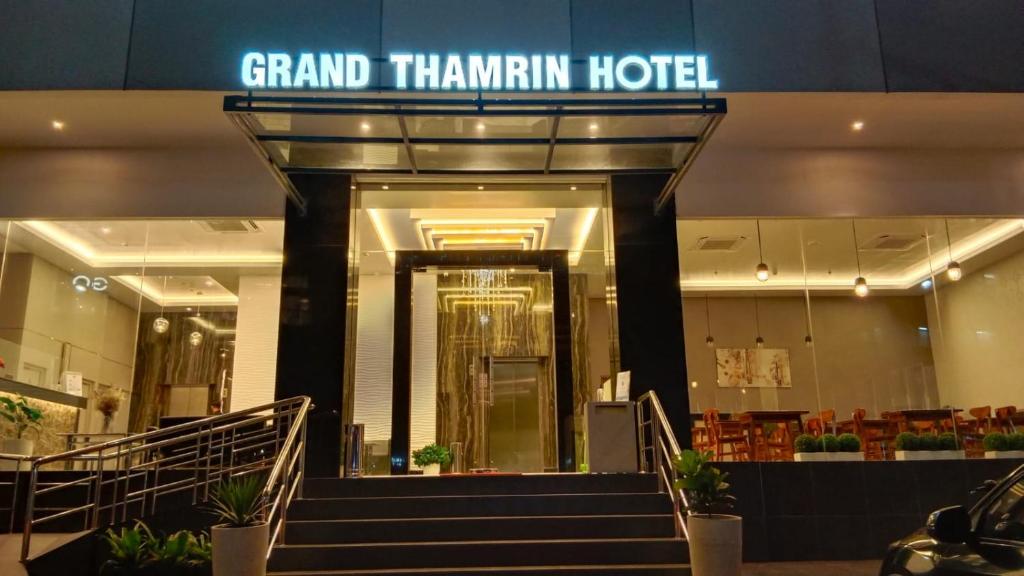 a grand hamlin hotel with stairs in a building at Grand Thamrin Hotel in Jakarta