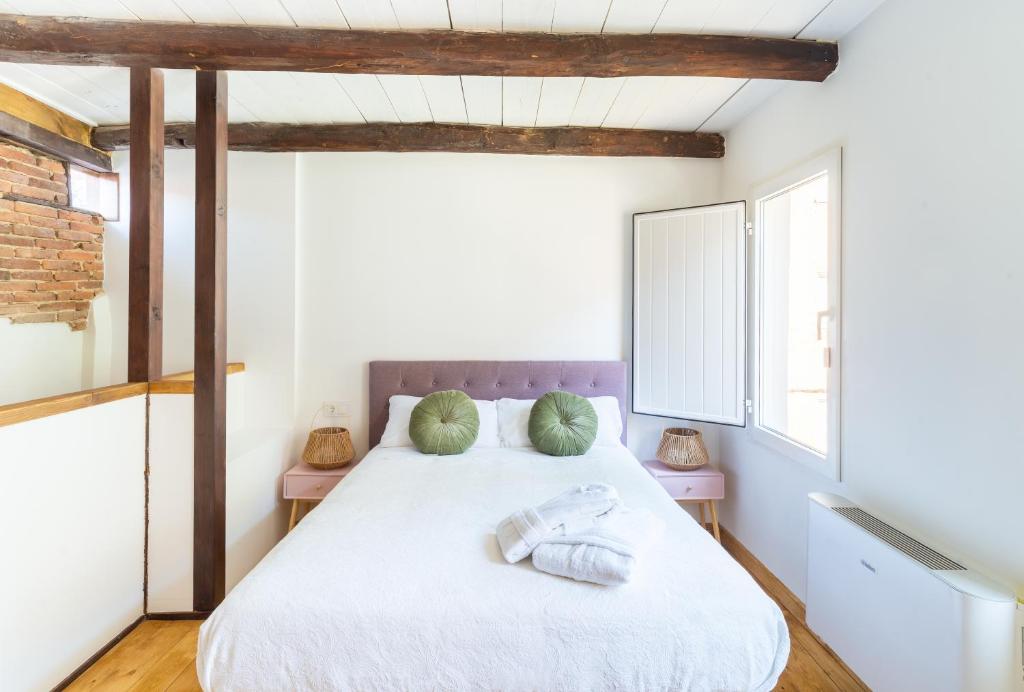 a bedroom with a bed with two pillows on it at VUT Domus Aurea in Astorga