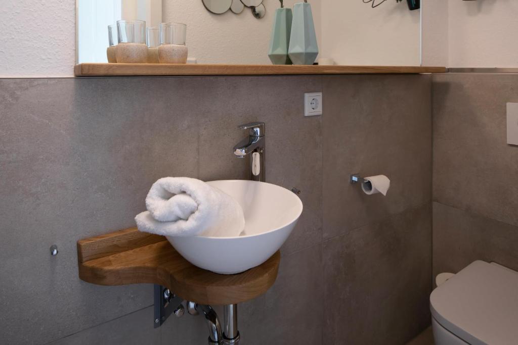 a bathroom with a sink with a towel in it at Plauderei Café und Hotel in Bad Zwischenahn