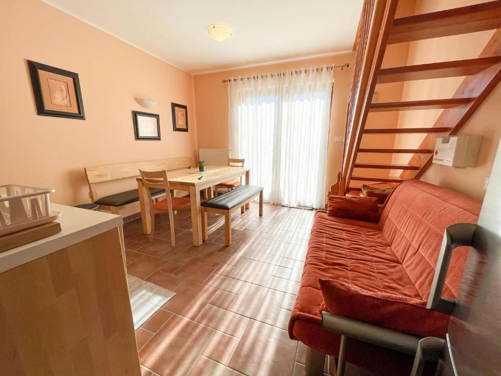 a living room with a couch and a table at Apartma Idila in Zreče