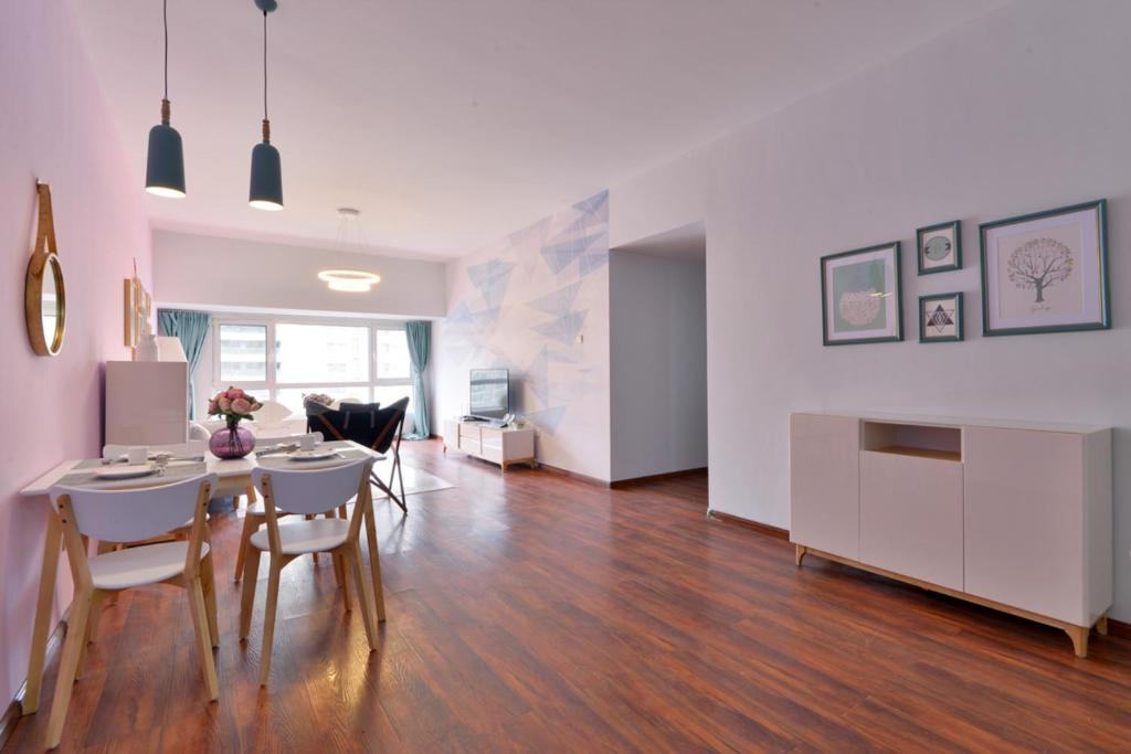 a kitchen and living room with a table and chairs at Locals Apartment House 90 in Tianjin