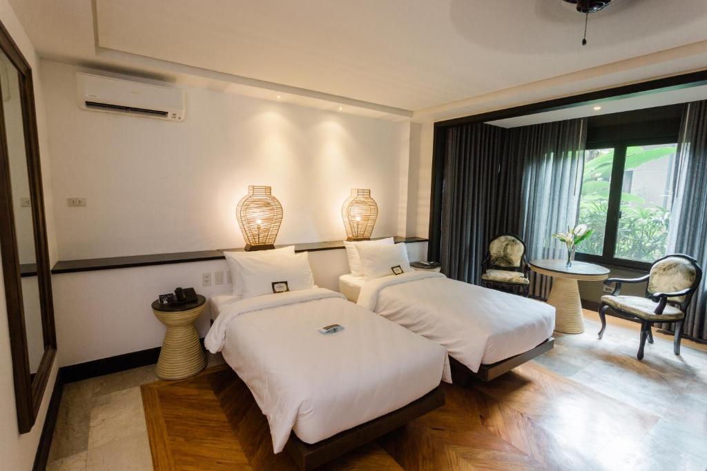 Postel nebo postele na pokoji v ubytování The Henry Resort Dumaguete