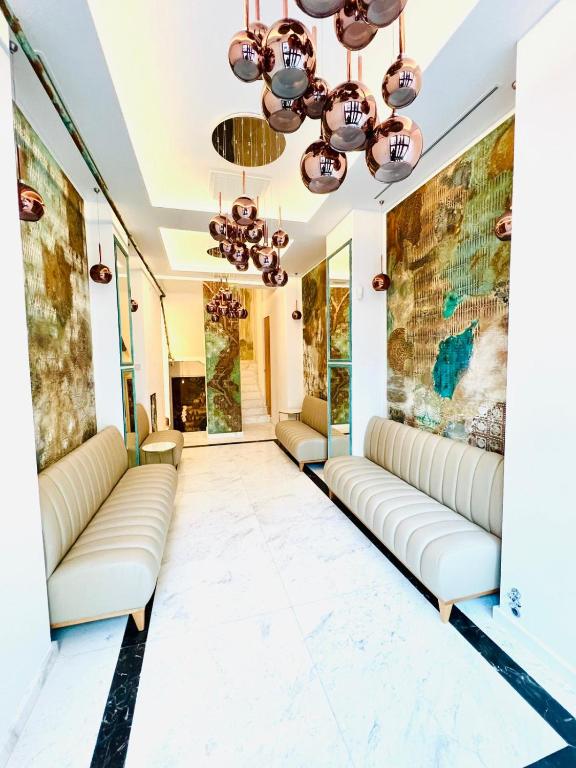a lobby with couches and paintings on the walls at House4You - Blanari in Bucharest