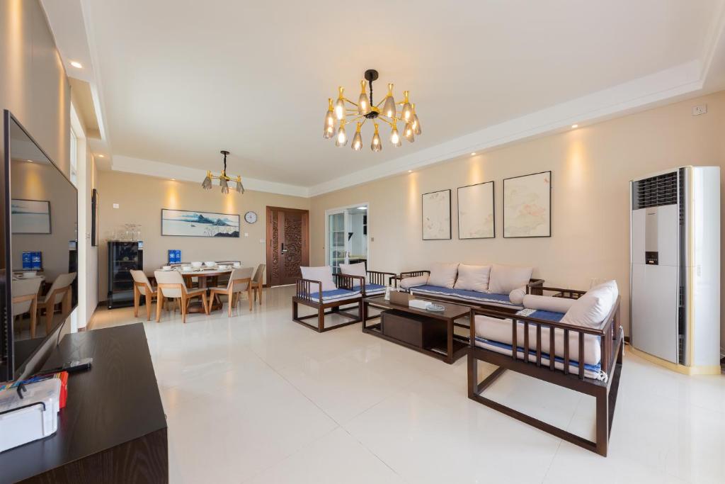 a living room with a couch and a dining room at Locals Apartment House 01 in Changliu