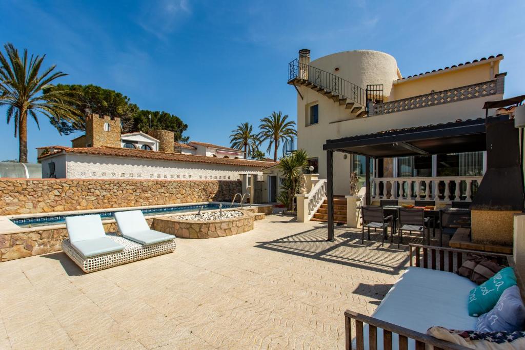 a house with a patio and a swimming pool at Villa Welcs EMP 017 con piscina en la mejor zona de Empuriabrava in Empuriabrava