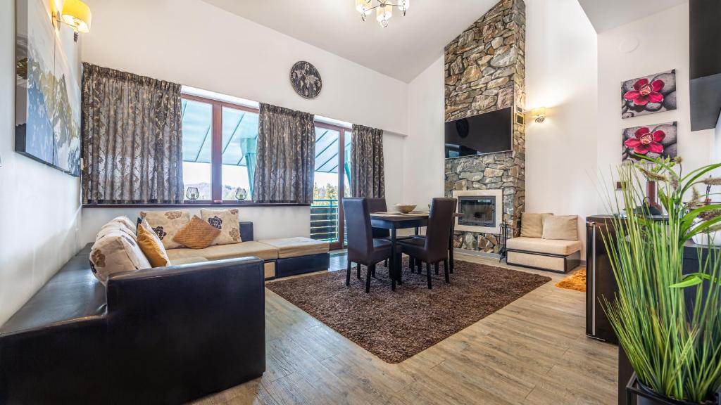 a living room with a couch and a table at Harmony Apartment in Silver Mountain in Poiana Brasov