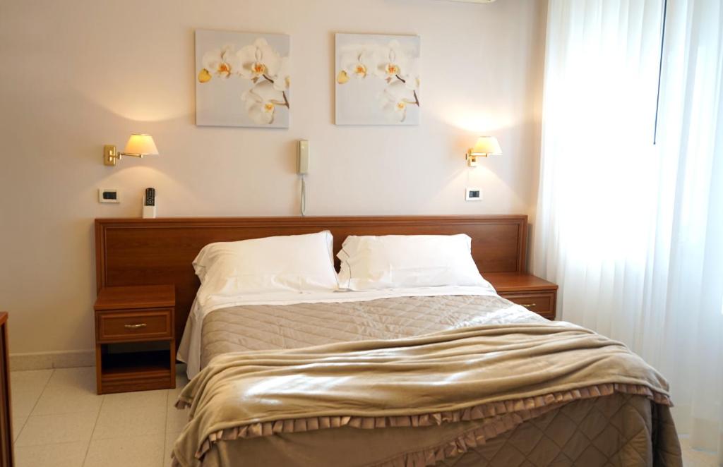 Postel nebo postele na pokoji v ubytování Hotel Marconi