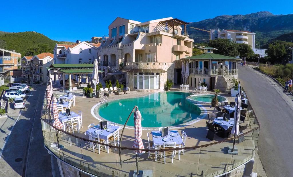 a resort with a swimming pool in front of a building at Spa Resort Luxury Apartments in Budva