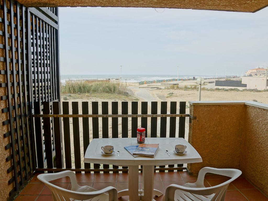 a table and chairs on a balcony with a view of the beach at Apartment Horizon Marin-2 by Interhome in Lacanau-Océan