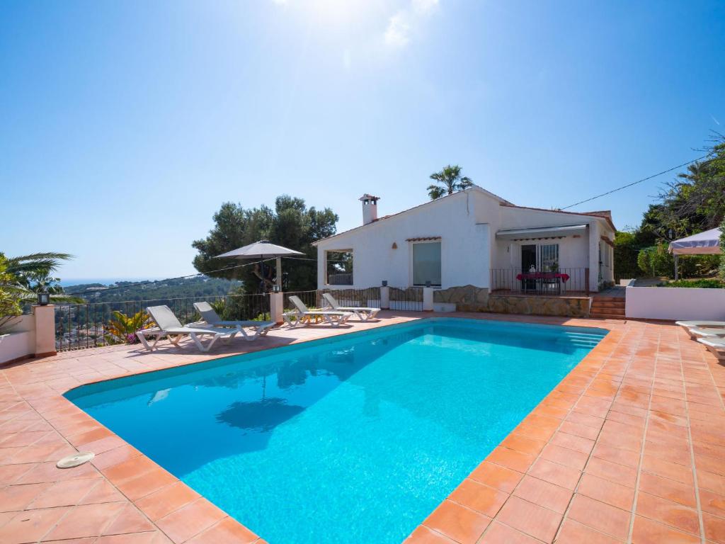 a swimming pool in front of a house at Holiday Home El Olivo by Interhome in Moraira