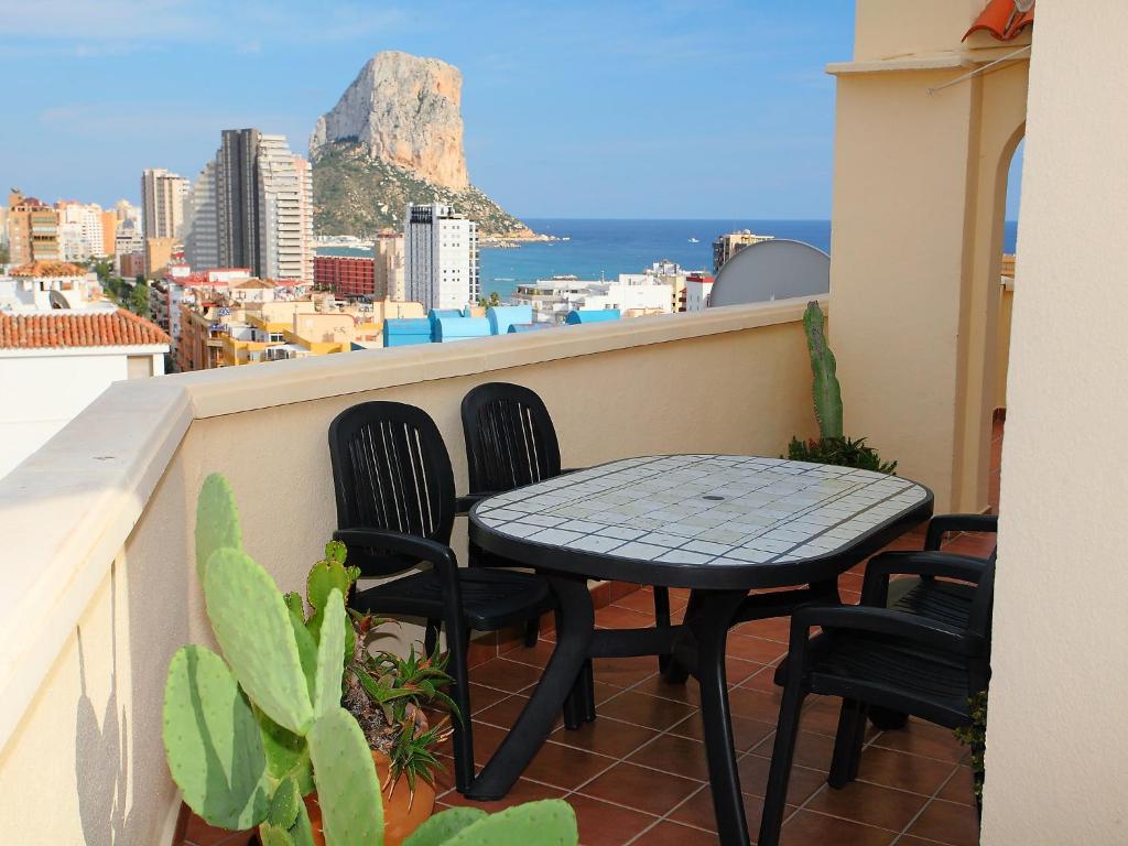a table and chairs on a balcony with a view of the city at Apartment Playsol-1 by Interhome in Calpe