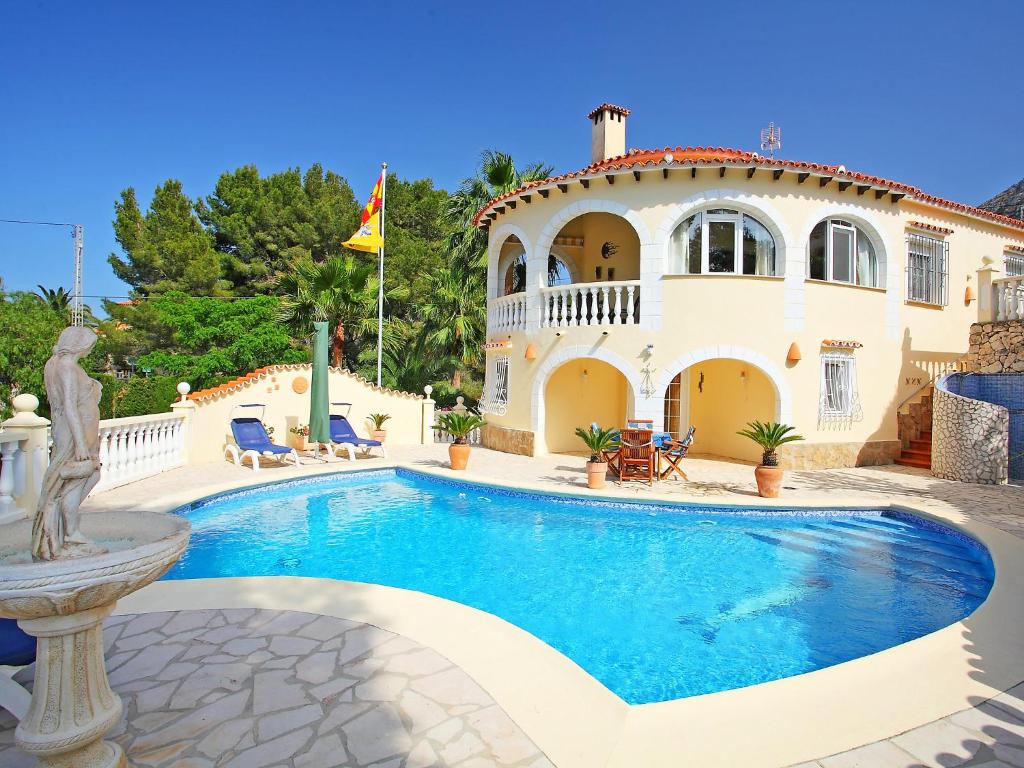 a large house with a swimming pool in front of it at Holiday Home Stella by Interhome in Denia