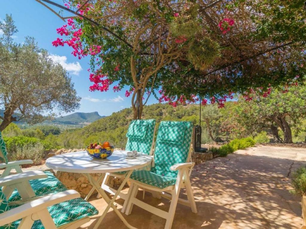 a table and chairs on a patio with a view at Holiday Home Can Tiona by Interhome in Andratx