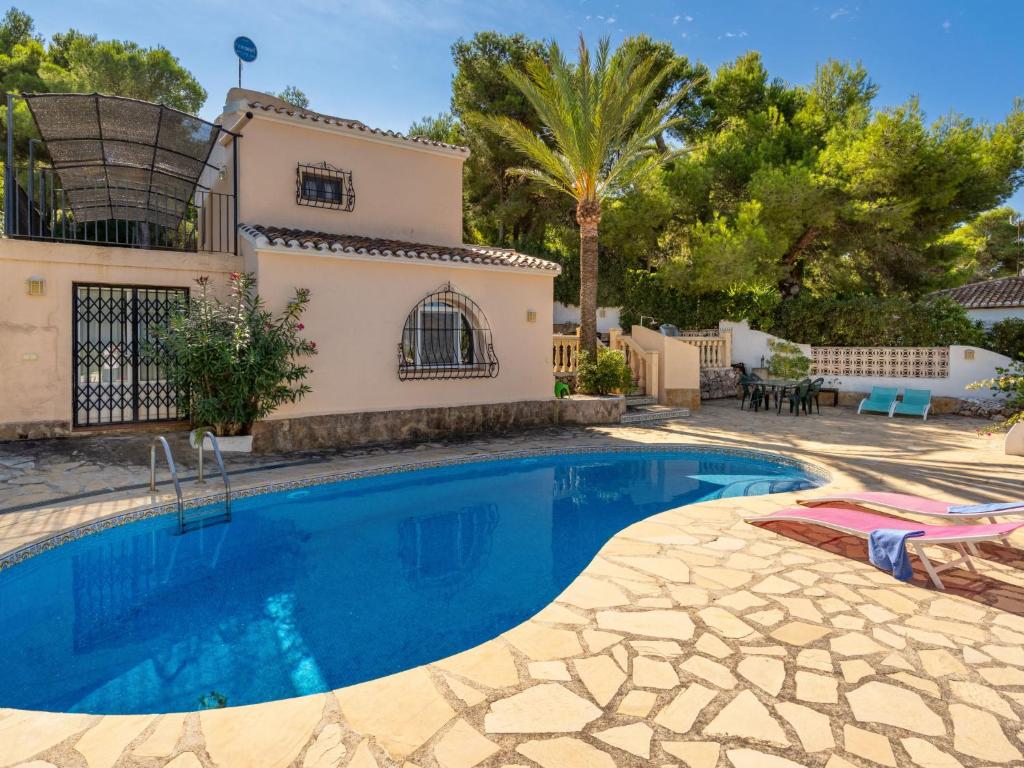 a swimming pool in front of a villa at Holiday Home Toscacasita by Interhome in Balcon del Mar