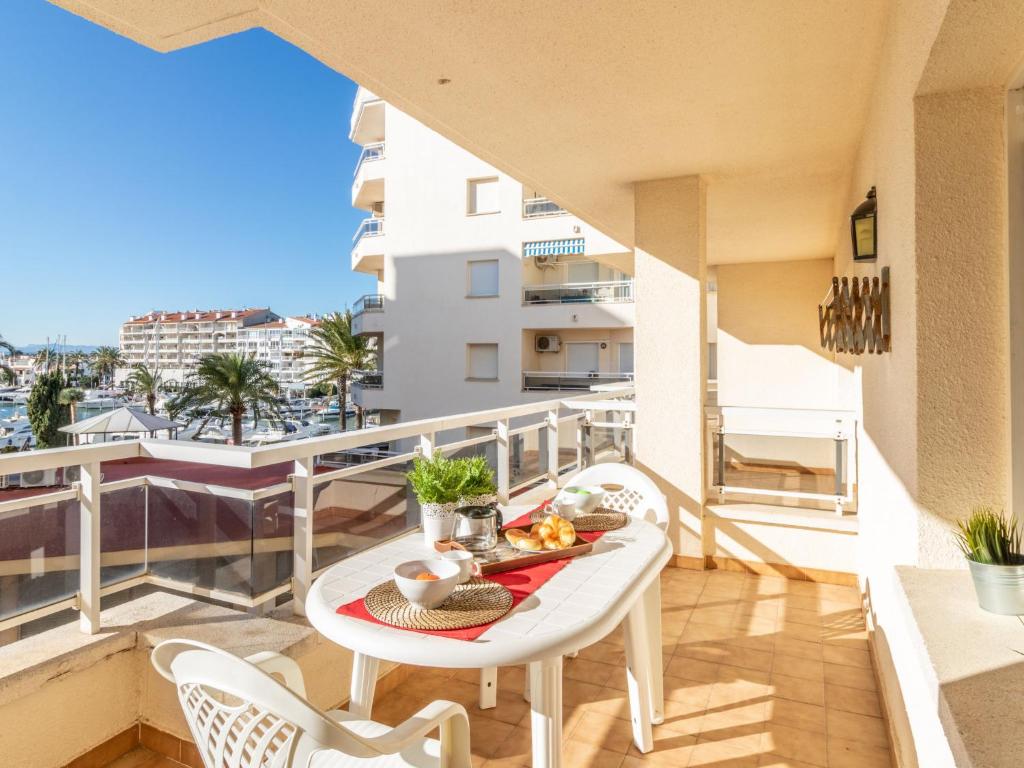 a balcony with a table with food on it at Apartment Club Nautic-9 by Interhome in Empuriabrava