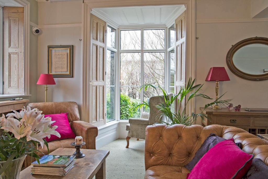 a living room with two couches and a large window at Sheriff Lodge in Matlock