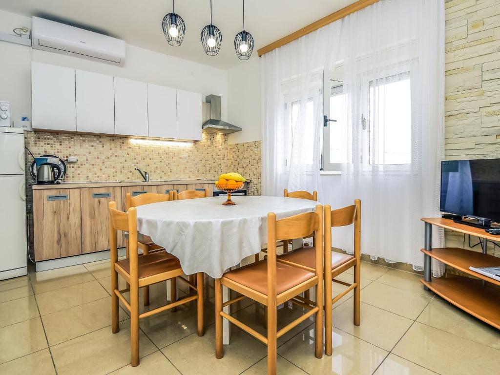 a kitchen with a table and chairs in a room at Holiday Home Ankica by Interhome in Pašman