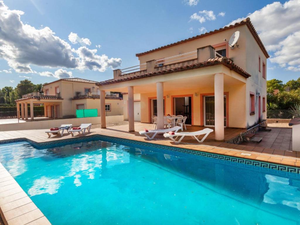 a villa with a swimming pool and a house at Villa Villa Cala Nova B by Interhome in Les tres Cales