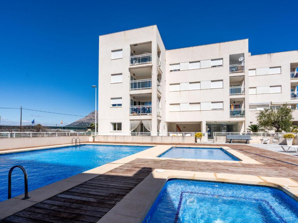 an apartment with a swimming pool in front of a building at Apartment Arenal-1 by Interhome in Jávea