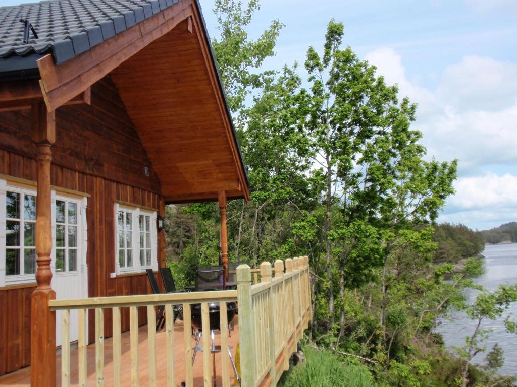 a house with a deck with a view of the water at Holiday Home Blåbærhytta by Interhome in Onarheim