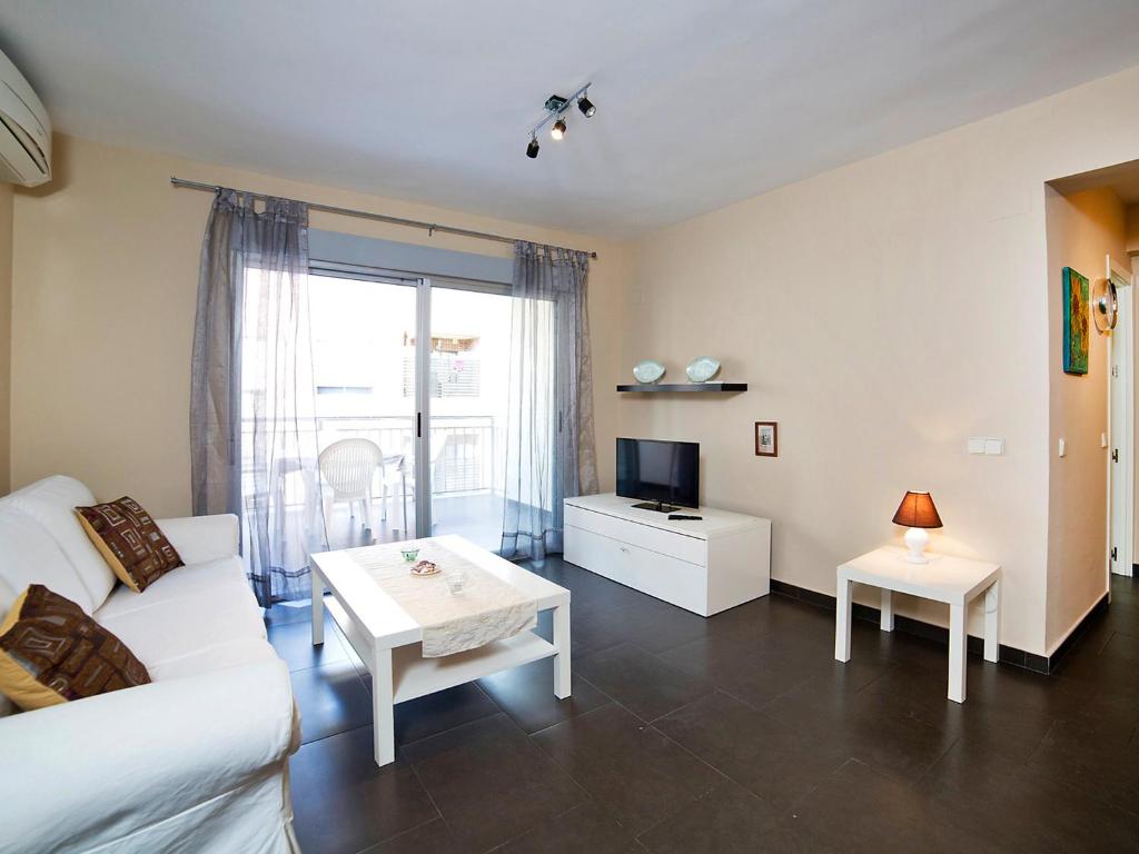 a living room with a white couch and a table at Apartment Gabriel by Interhome in Calpe