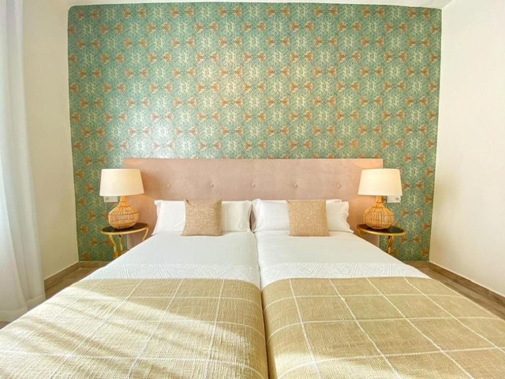 A bed or beds in a room at iloftmalaga Plaza Marina