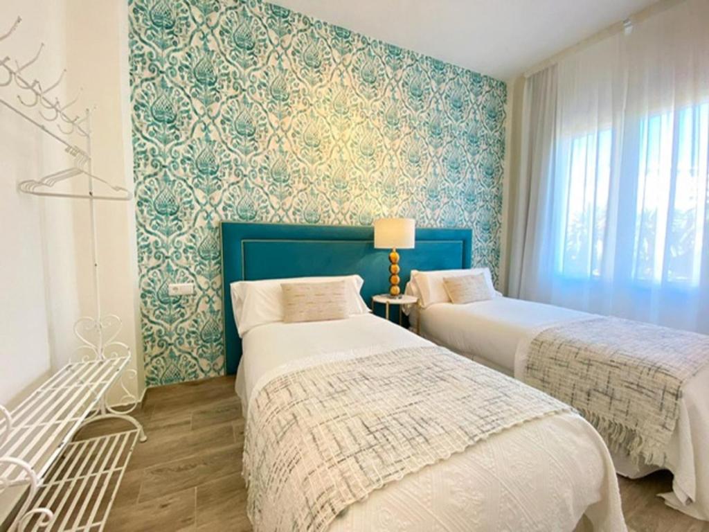 A bed or beds in a room at iloftmalaga Plaza Marina