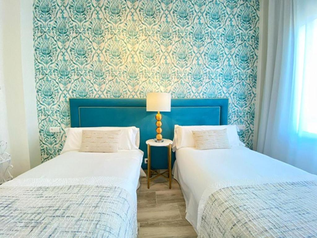 A bed or beds in a room at iloftmalaga Plaza Marina