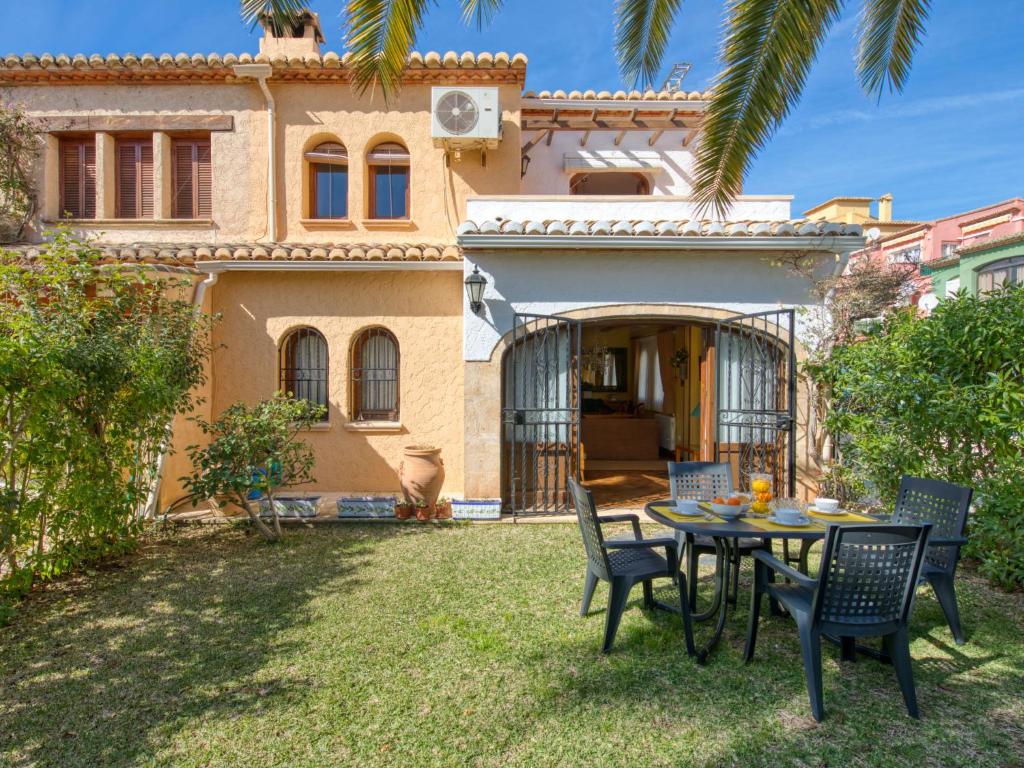 a patio with a table and chairs in front of a house at Holiday Home El Arenal by Interhome in Jávea