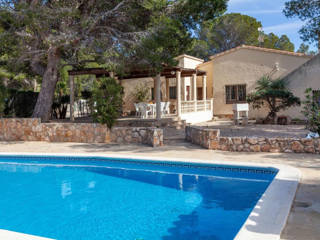 a house with a swimming pool in front of a house at Villa Villa Illot by Interhome in Les tres Cales