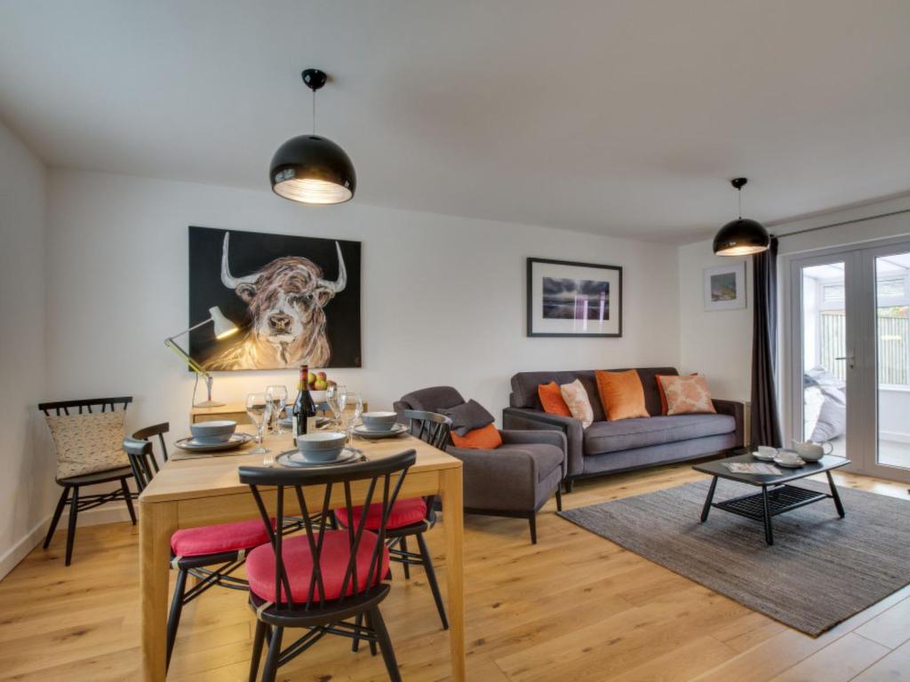 a living room with a table and a couch at Holiday Home Glynn Terrace by Interhome in Padstow