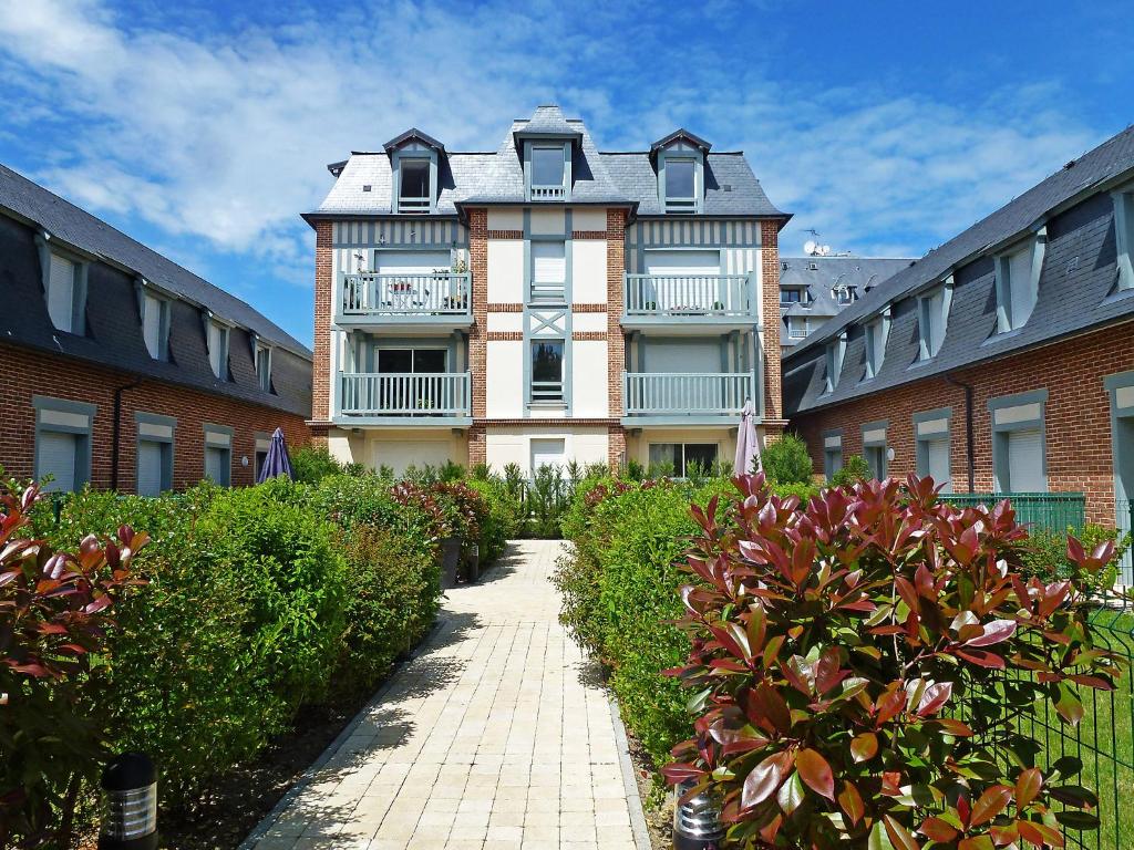 an apartment building with a walkway in front of it at Holiday Home Villa Morny-1 by Interhome in Deauville