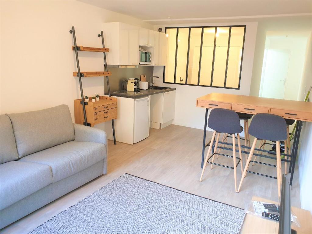 un salon avec un canapé et une table et une cuisine dans l'établissement Dana centre mer 11, à Nice