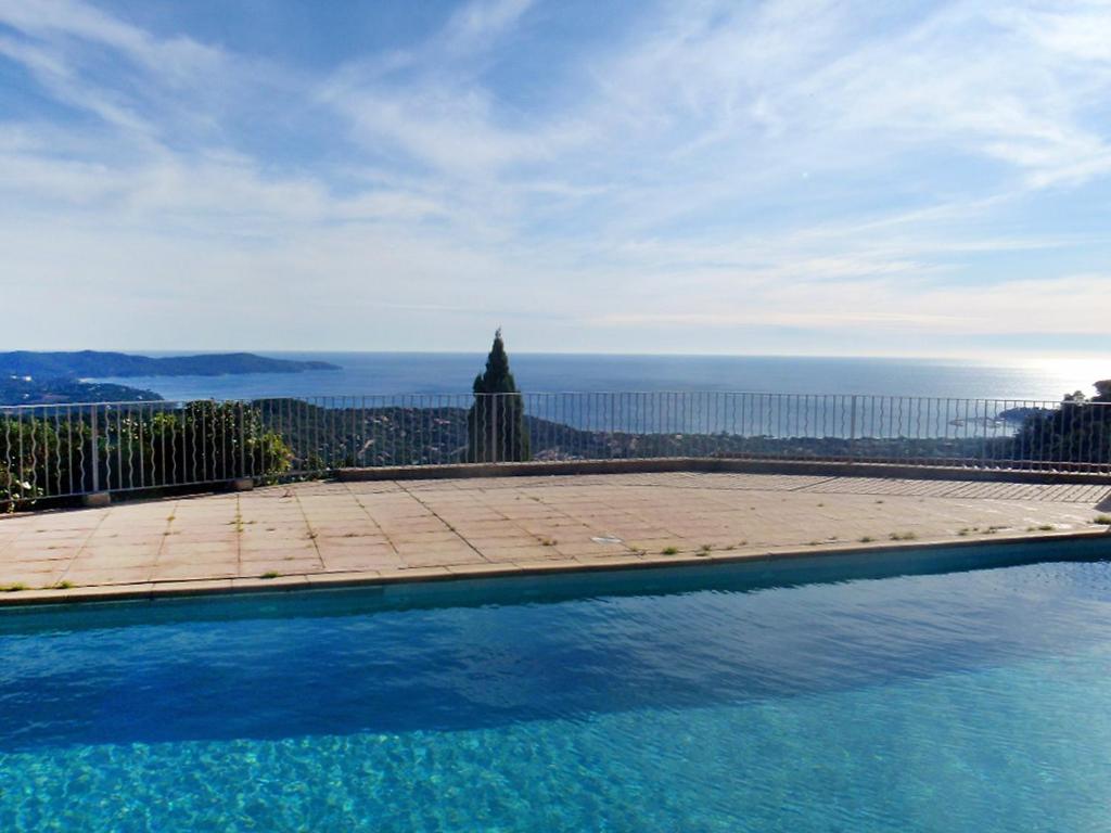 a swimming pool with a view of the ocean at Apartment Les Sauvagières II-1 by Interhome in Cavalaire-sur-Mer