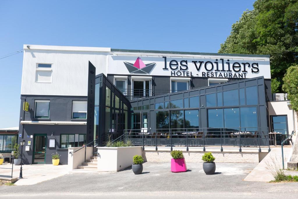 a building with a sign that reads las vittoria hotel apartment at Logis Les Voiliers in Peigney