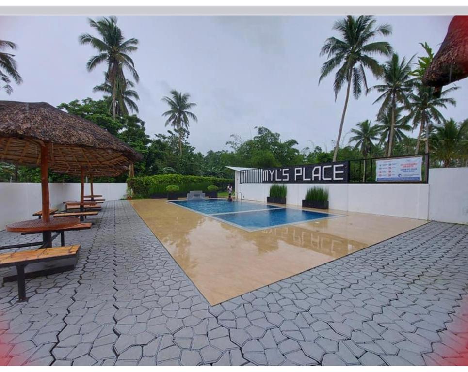 a resort with a swimming pool and amimics place sign on at Dreamink farm og Myl`s place in Sorsogon