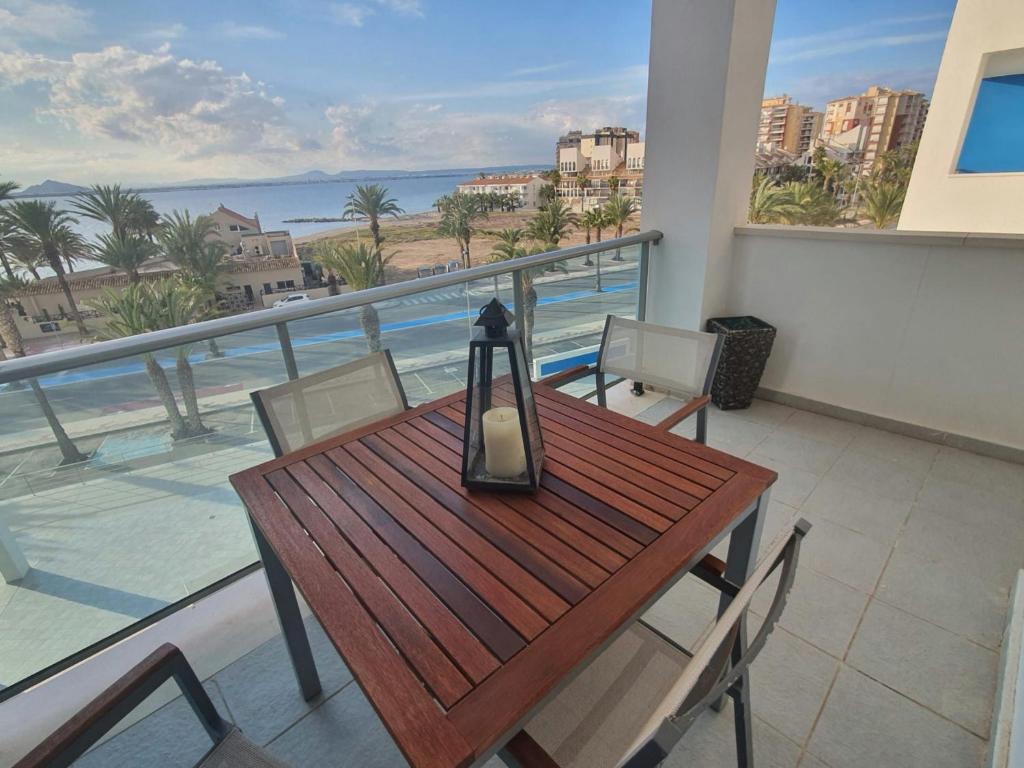a table and chairs on a balcony with a view of the ocean at Mar Azul 243 Manga Norte in La Manga del Mar Menor