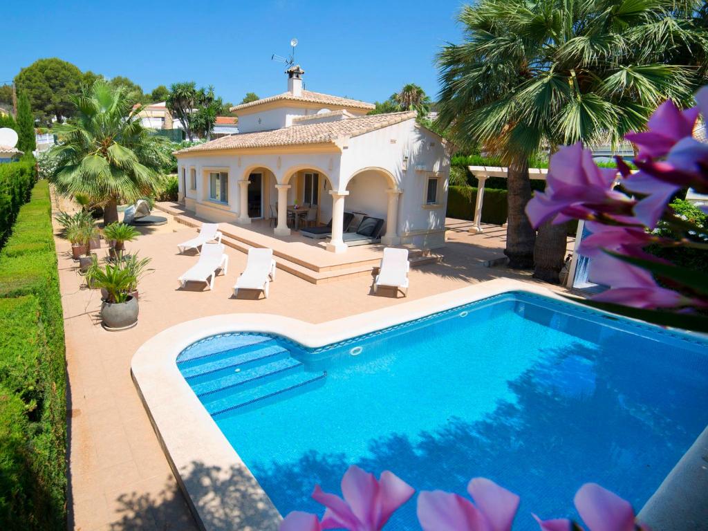 a villa with a swimming pool in front of a house at Holiday Home Casa Kate by Interhome in Calpe