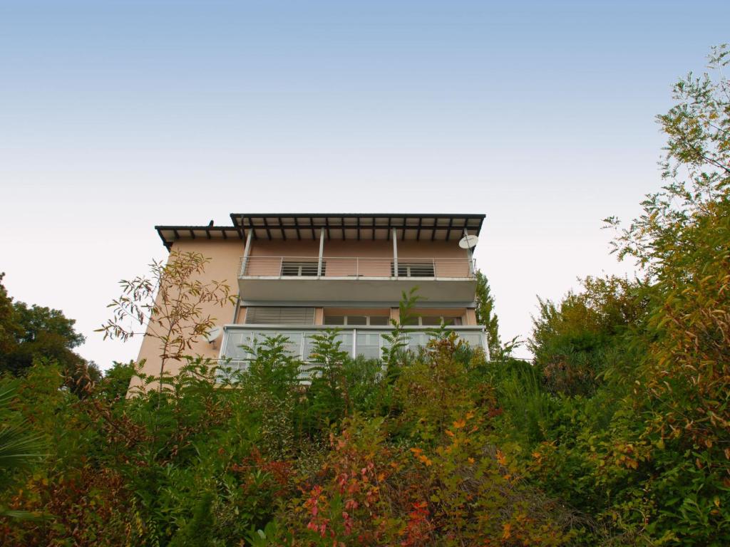 a tall building on top of a hill with trees at Holiday Home Daniele by Interhome in Cademario