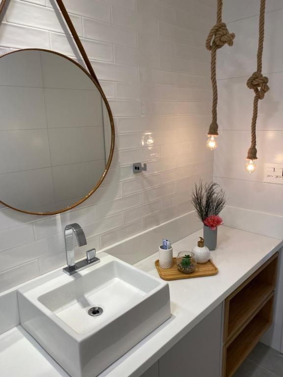 a bathroom with a white sink and a mirror at Eco resort Praia dos Carneiros in Praia dos Carneiros