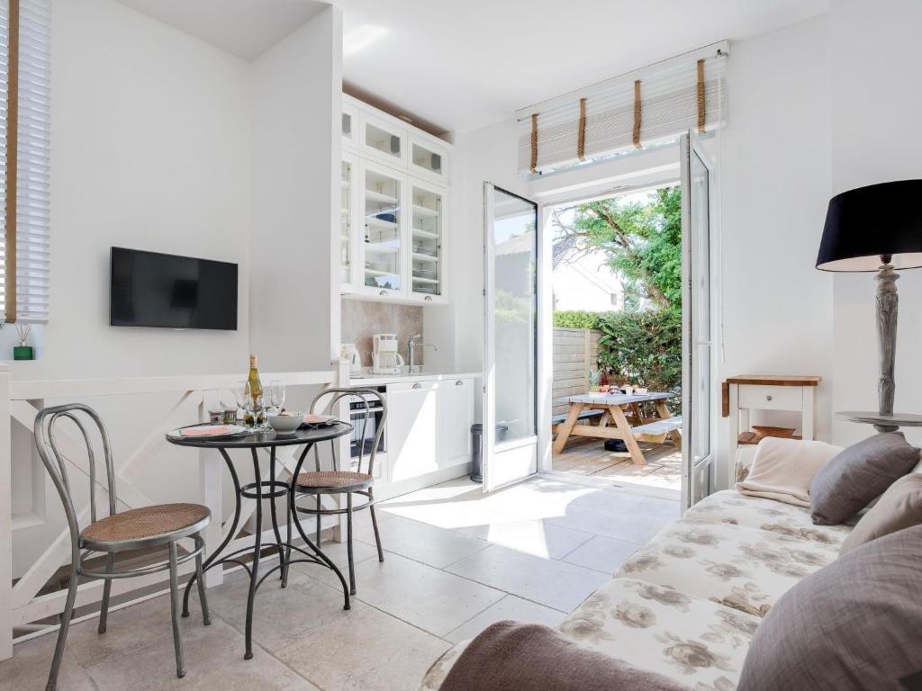 a living room with a couch and a table at Apartment L'Abeille d'Or by Interhome in Carnac